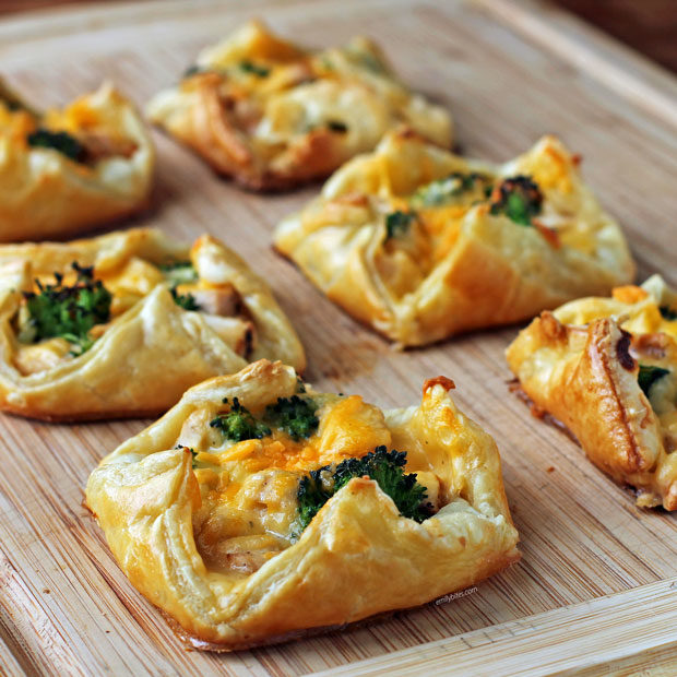 Cheesy Chicken and Broccoli Pastry Bundles on a cutting board