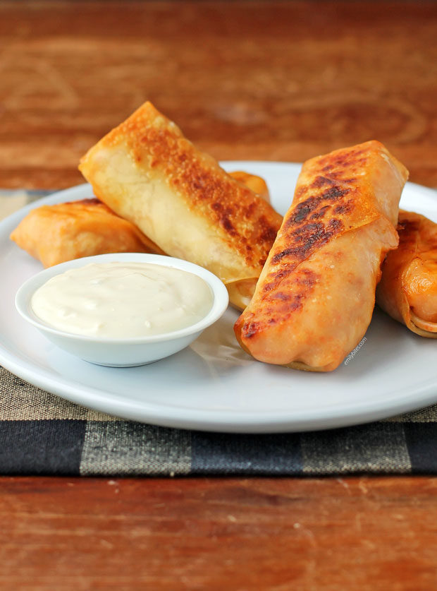 Buffalo Chicken Egg Rolls on a plate with blue cheese