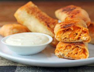 Buffalo Chicken Egg Rolls stacked on a plate
