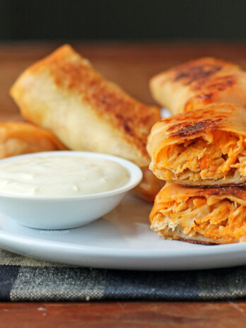 Buffalo Chicken Egg Rolls stacked on a plate