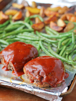 Sheet Pan Meatloaves with Roasted Potatoes and Green Beans on the pan