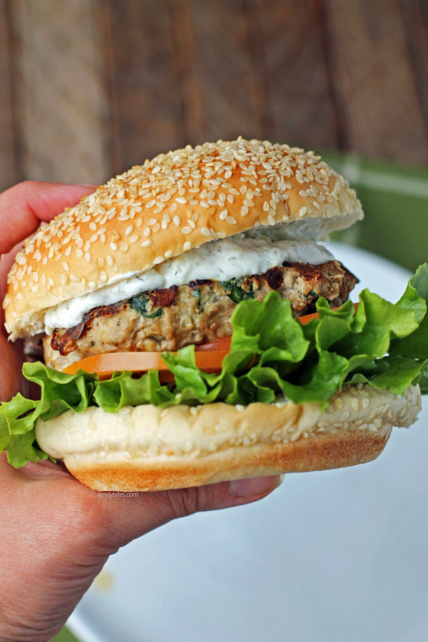 Hand golding a Greek turkey burger