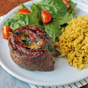 Garlic Parmesan Flank Steak Pinwheel with salad and rice