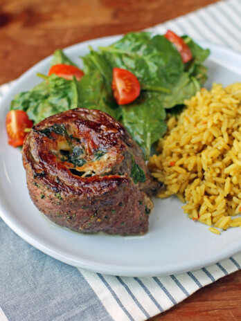 Garlic Parmesan Flank Steak Pinwheel with salad and rice