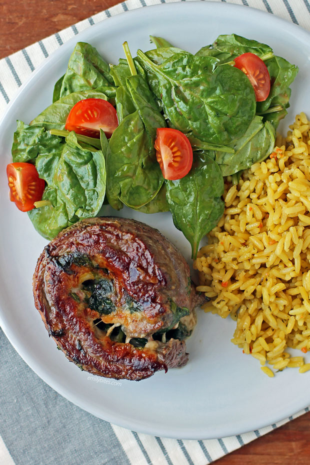 Garlic Parmesan Flank Steak Pinwheel on a plate with sides