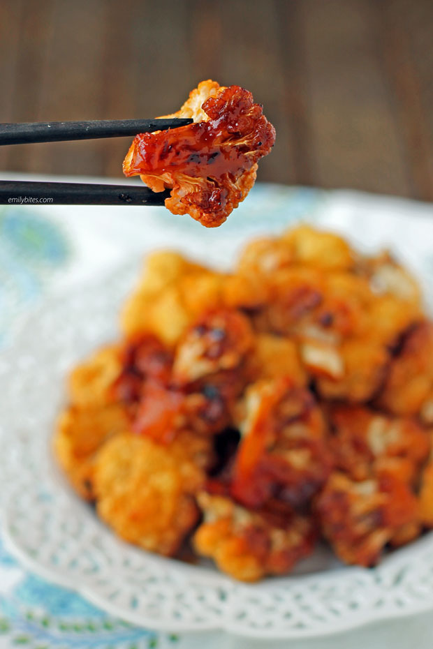 One piece of Sweet and Spicy Roasted Cauliflower in chopsticks