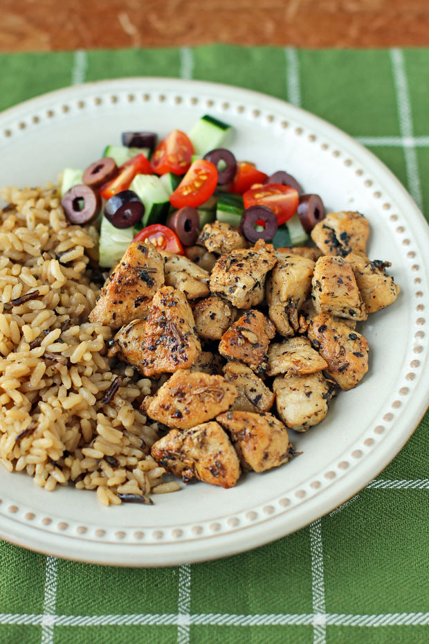 Greek Chicken Bites on a plate with rice and veggies