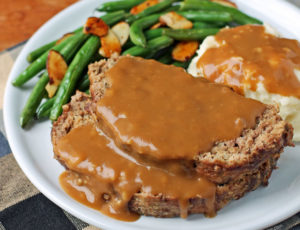Meatloaf with Gravy on a plate with sides