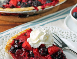 Mixed Berry Pie slice with whipped cream