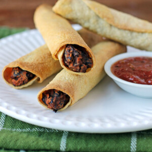 Black Bean Taquitos on a plate with salsa