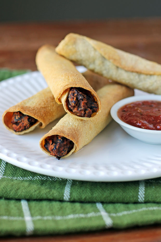 Black Bean Taquitos on a plate with salsa