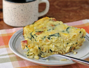 Bacon and Spinach Hash Brown Egg Bake with a forkful