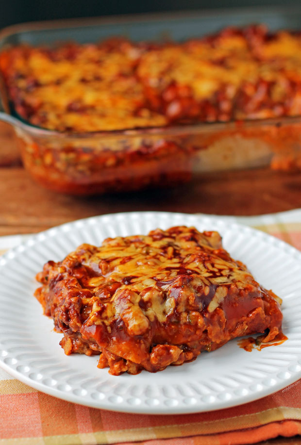 Layered Meat and Bean Enchilada Bake serving on a plate