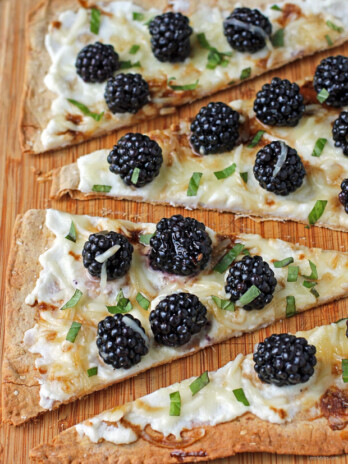 Blackberry Ricotta Flatbread sliced on a cutting board