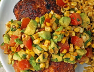 Blackened Chicken with Avocado Corn Topping plated with rice