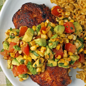 Blackened Chicken with Avocado Corn Topping plated with rice