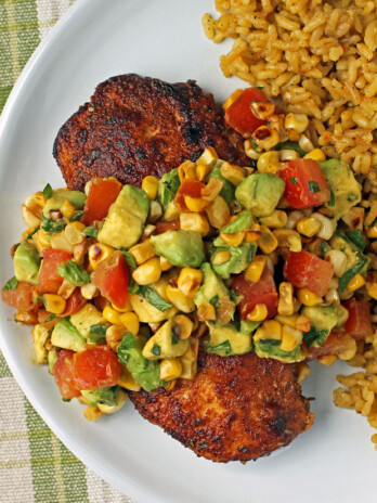 Blackened Chicken with Avocado Corn Topping plated with rice