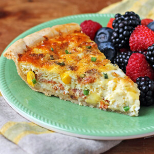 Bacon and Corn Quiche slice on a plate