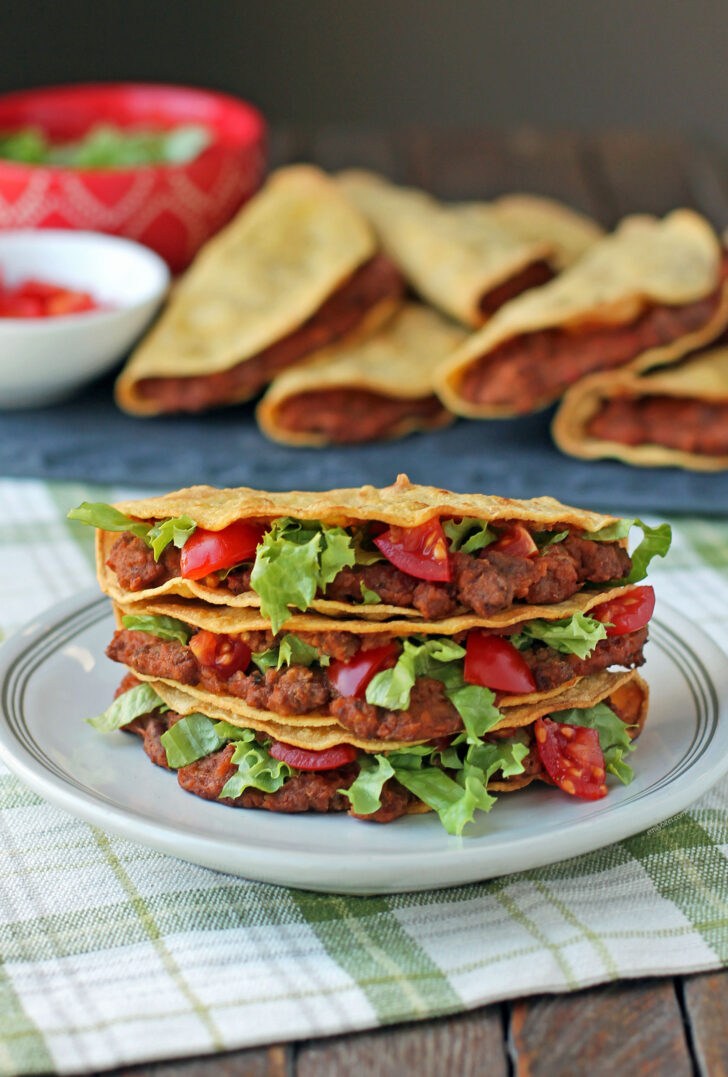 Baked Beef and Bean Tacos stacked with toppings