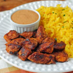 Mexi Chicken Bites plated with rice and dipping sauce