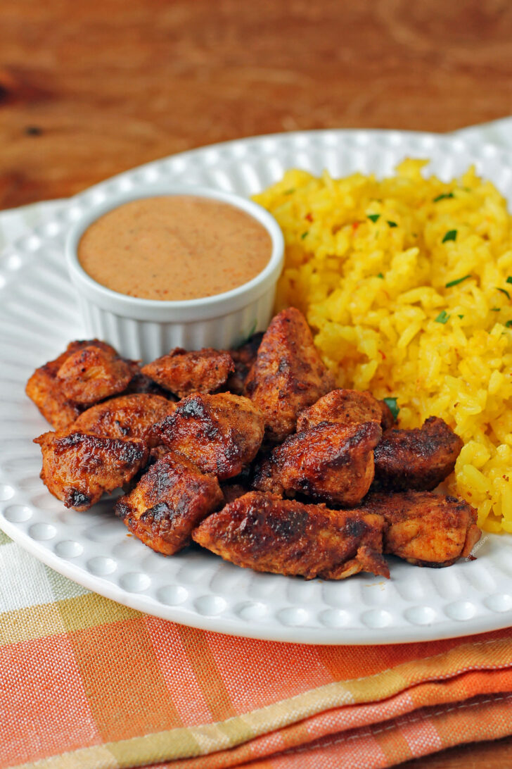 Mexi Chicken Bites plated with rice and dipping sauce