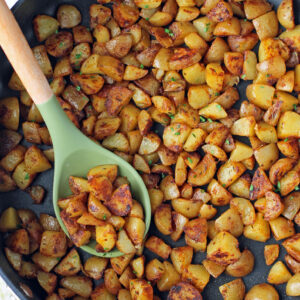 Skillet Breakfast Potatoes in a pan with a spoon