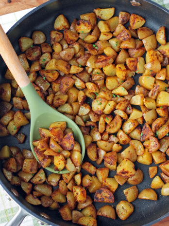 Skillet Breakfast Potatoes in a pan with a spoon