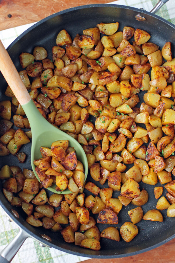 Skillet Breakfast Potatoes in a pan with a spoon