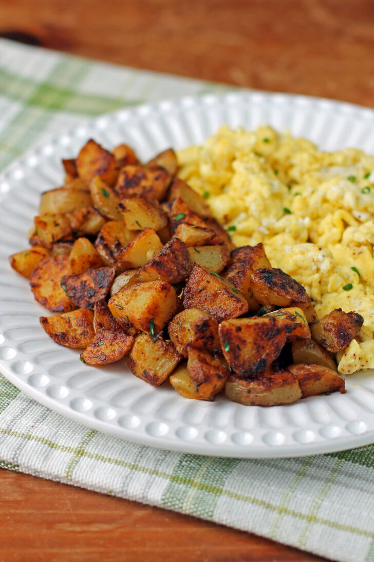 Skillet Breakfast Potatoes plated with eggs