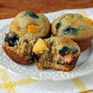 Peach Blueberry Muffins torn open on a plate