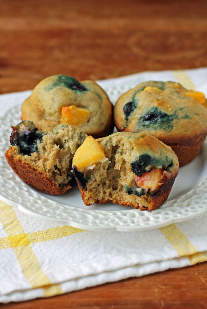 Peach Blueberry Muffins torn open on a plate