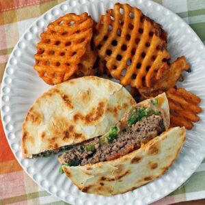 Quesadilla Burger with fries on a plate