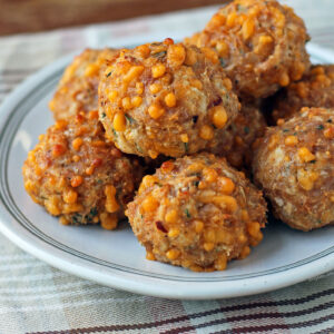 Bisquick Chicken Sausage Balls stacked on a plate close up