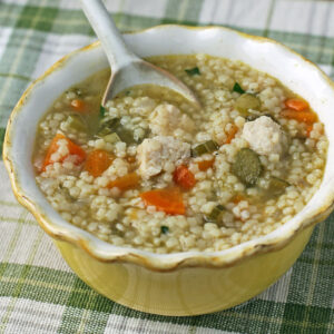 Chicken and Stars Soup in a bowl with a spoon