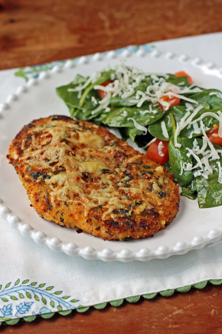 Crispy Garlic Parmesan Chicken plated with salad