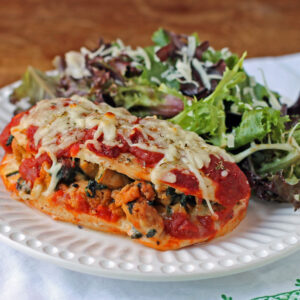 Italian Sausage Stuffed Chicken Bake plated with salad
