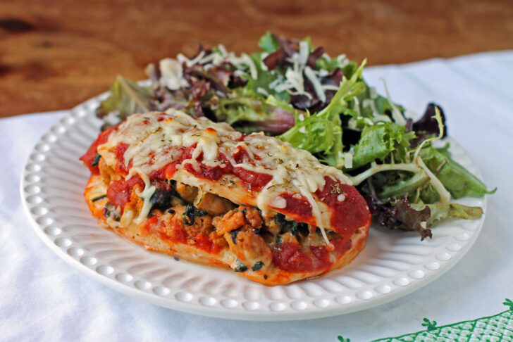 Italian Sausage Stuffed Chicken Bake plated with salad