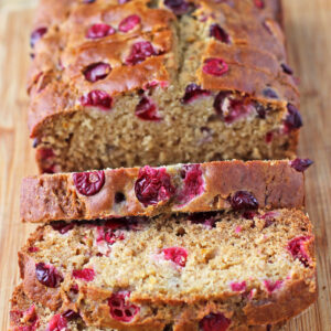 Orange Cranberry Bread sliced on a cutting board