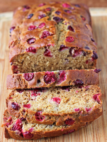 Orange Cranberry Bread sliced on a cutting board