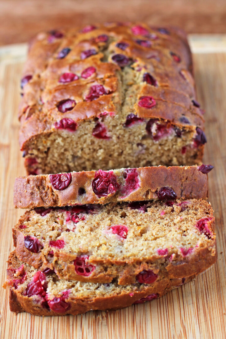 Orange Cranberry Bread sliced on a cutting board