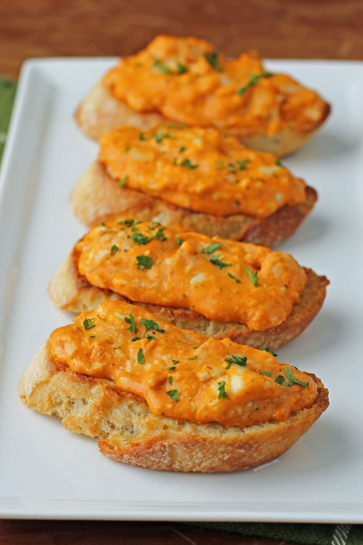 Cheesy Buffalo Chicken Toasts lined up on a plate