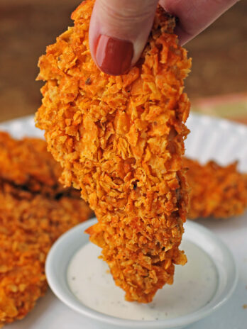 Doritos-Crusted Chicken Tender getting dipped into ranch dressing