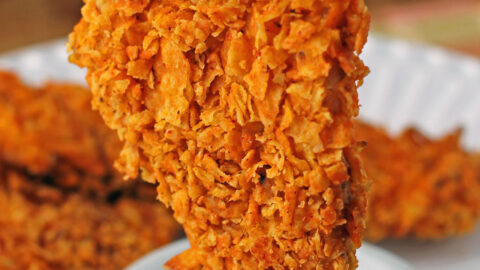 Doritos-Crusted Chicken Tender getting dipped into ranch dressing