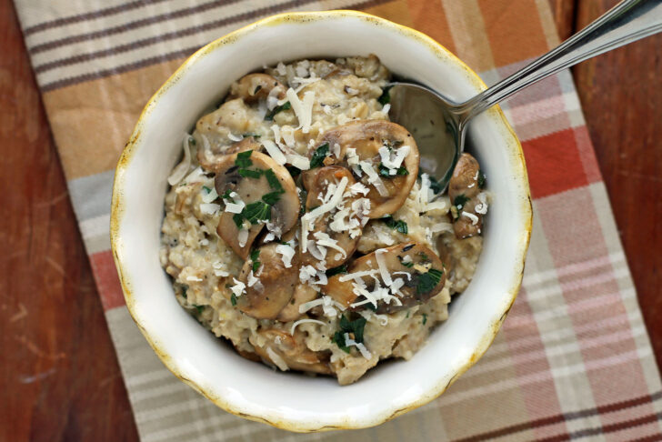 Savory Garlic Parmesan Oatmeal with Mushrooms in a bowl with a spoon