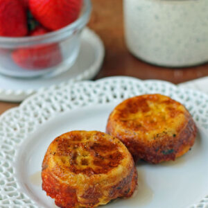 Waffle Bacon and Egg Cups plated with coffee and strawberries