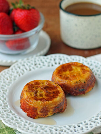 Waffle Bacon and Egg Cups plated with coffee and strawberries