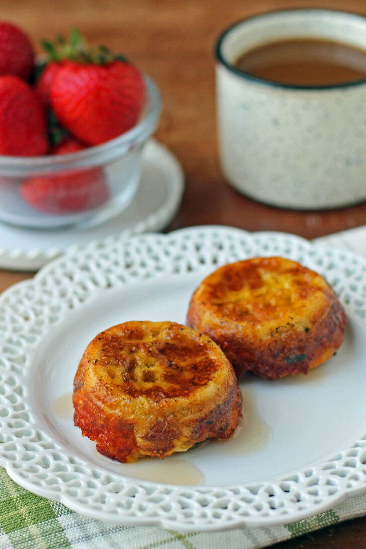 Waffle Bacon and Egg Cups plated with coffee and strawberries
