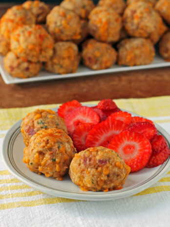 Maple Bacon Bisquick Sausage Balls plated with strawberries