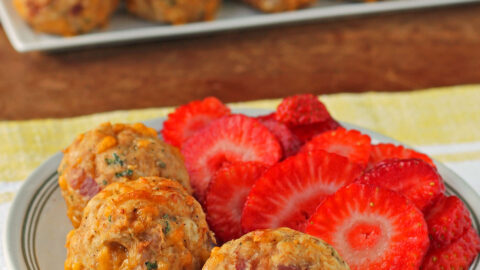 Maple Bacon Bisquick Sausage Balls plated with strawberries