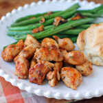 Kentucky Chicken Bites on a plate with green beans and a biscuit